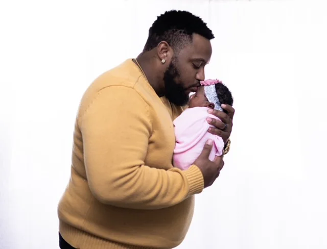 Newborn resting with dad